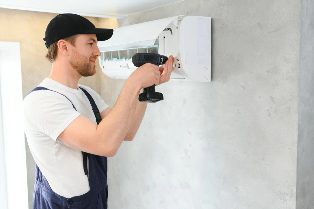 AC Replacement service technician installing a split air conditioner in Sharjah