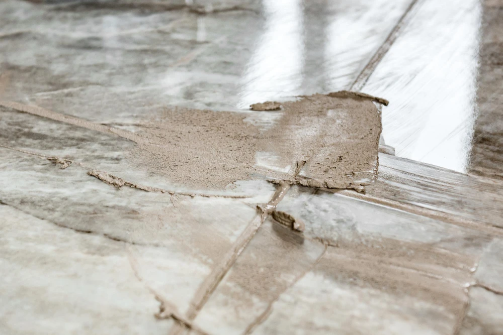 Why are my floor tiles popping up with raised and damaged floor tiles
